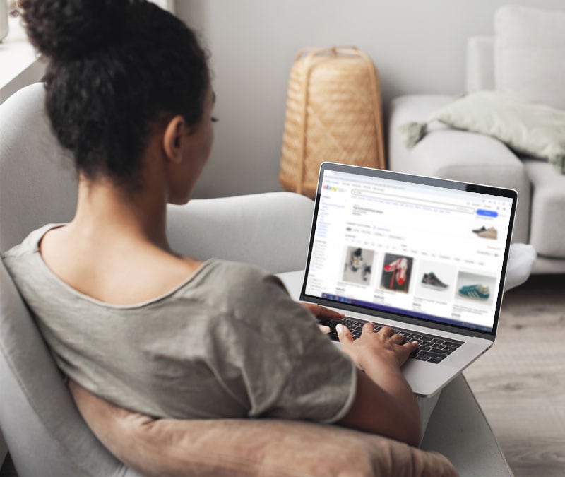 A woman browsing eBay on her laptop.