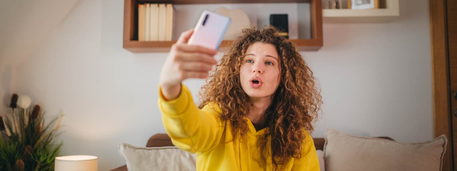 A woman records herself for a TikTok video and later wonders, 'Is TikTok safe?'