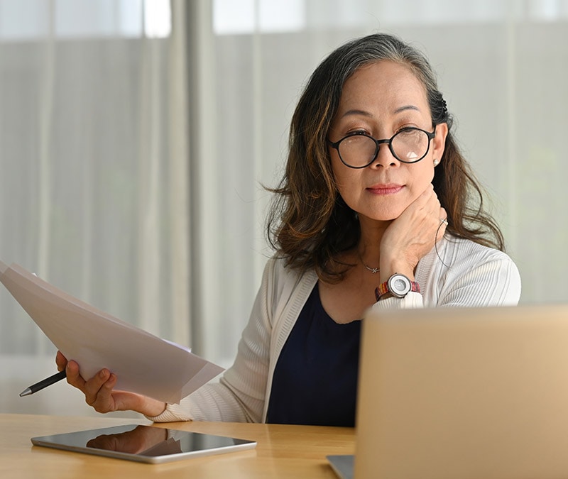 A woman checks her computer to make sure there aren't any computer virus signs.