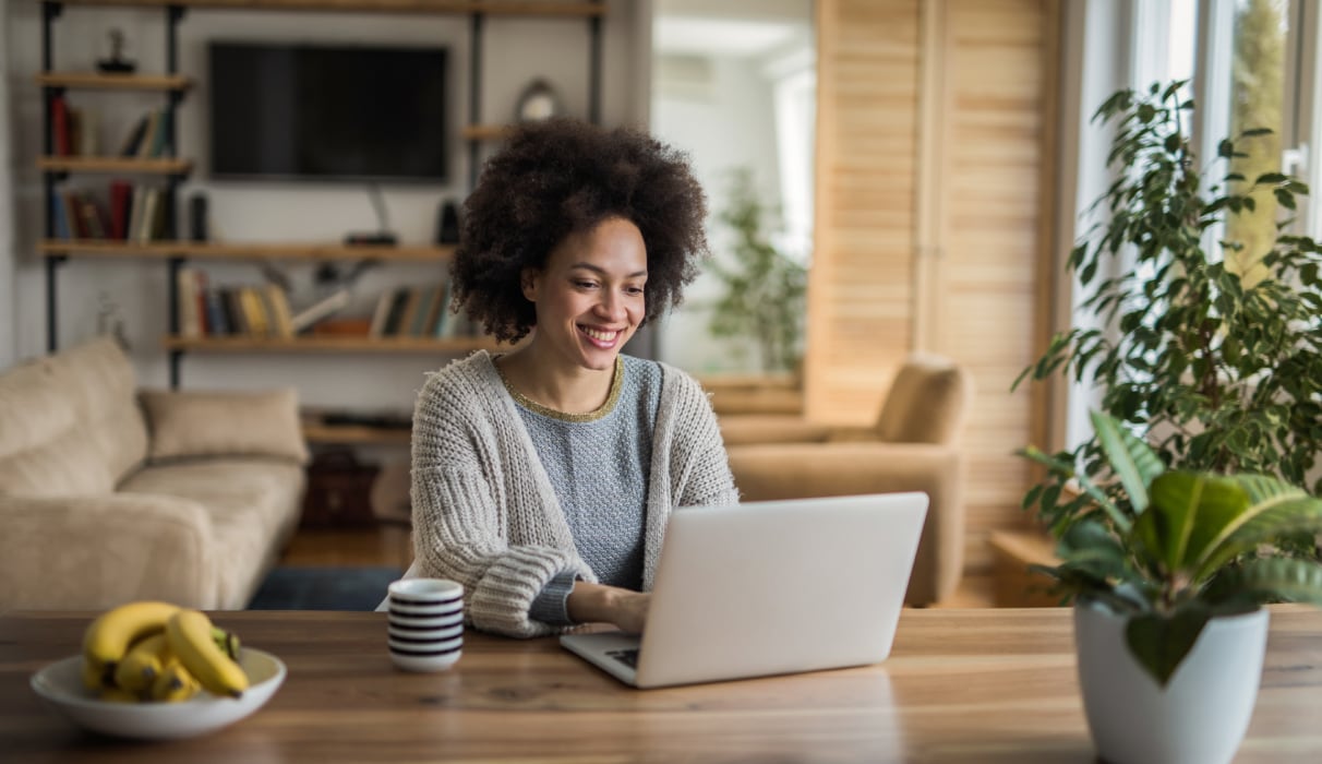 Woman smiling looking at a laptop