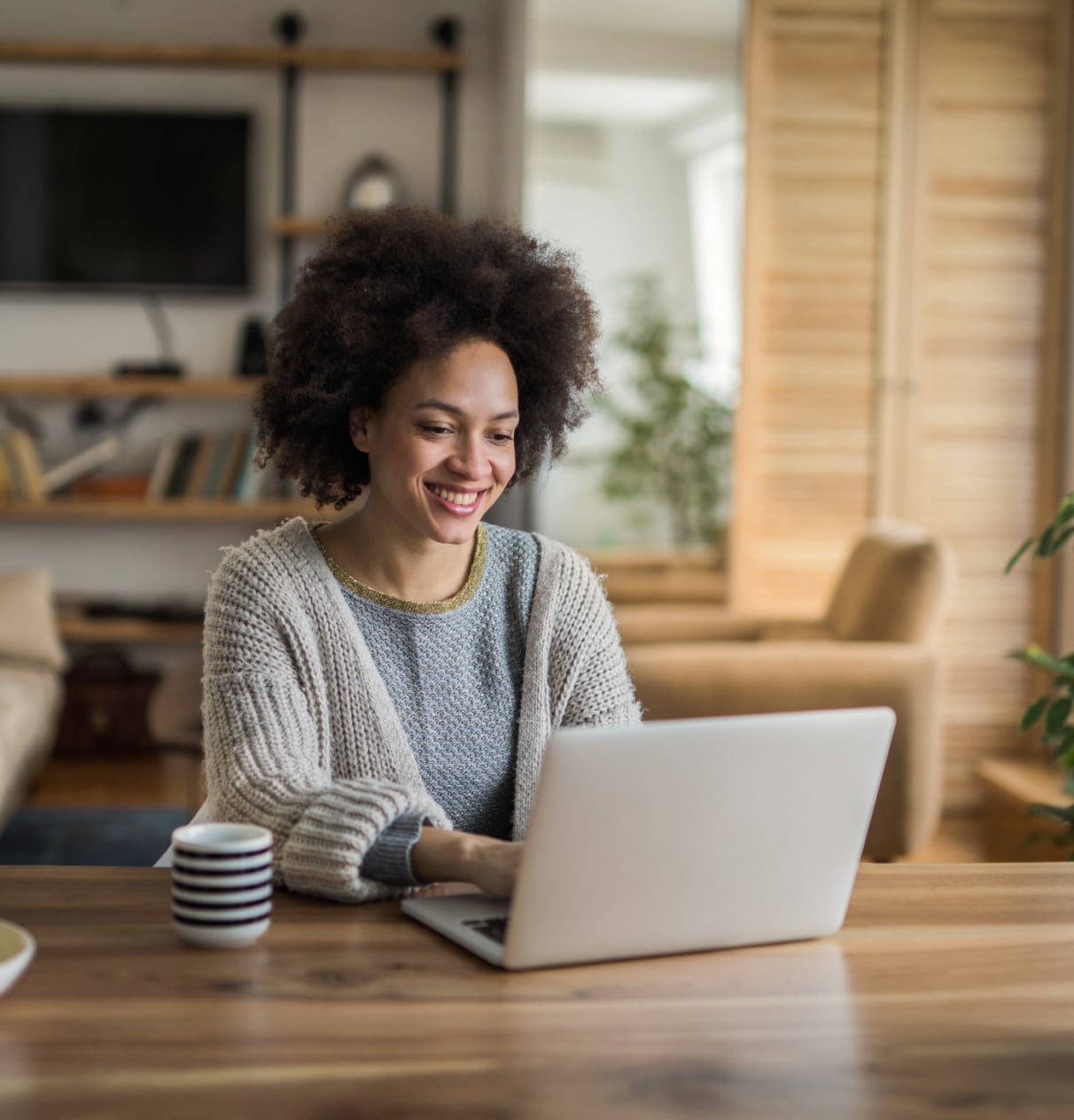 Woman smiling while looking at a laptop