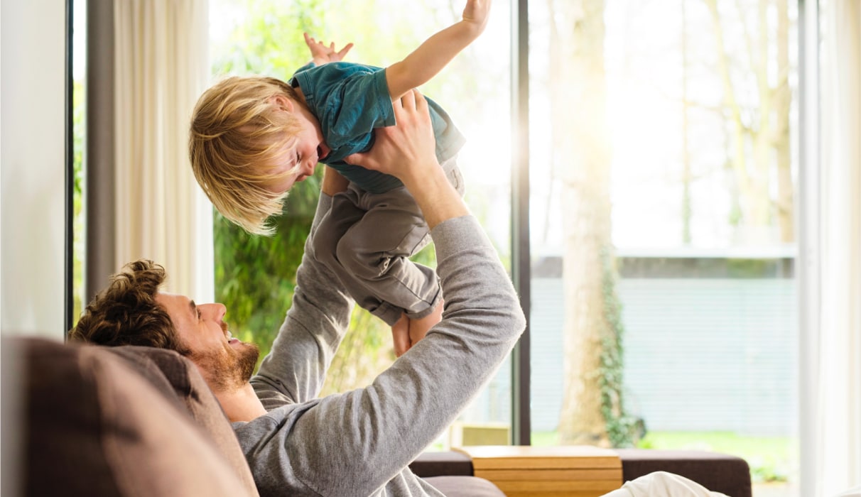 Man holding a child in the air