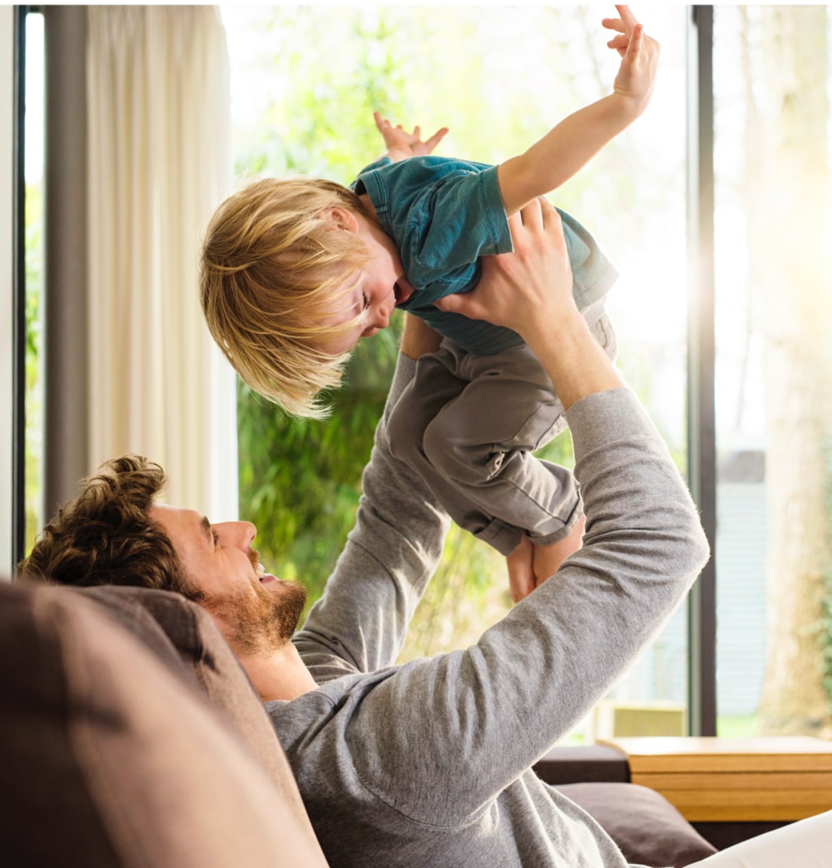 Man holding a child in the air