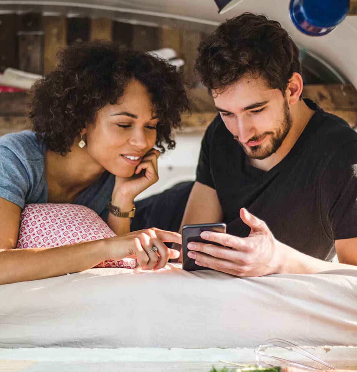 man and woman looking at a mobile phone