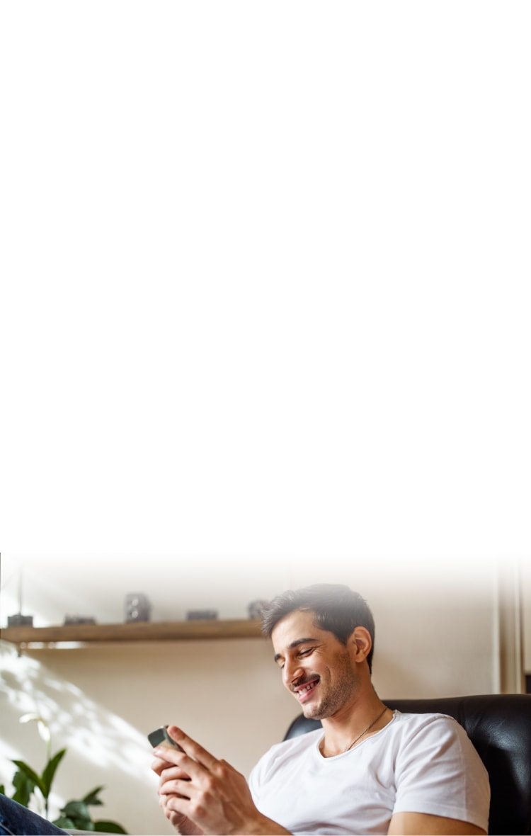 Smiling man looking at a mobile phone