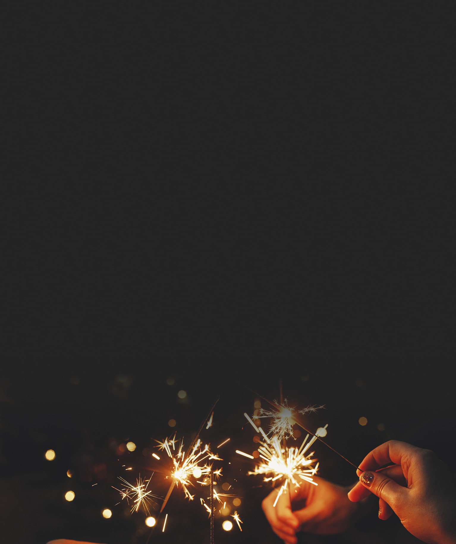 Woman sitting on a couch with a dog and using a laptop