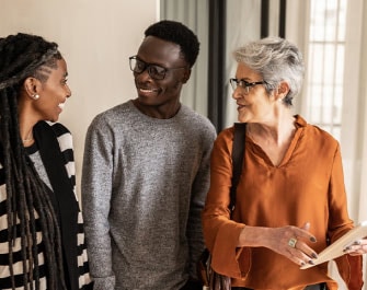 Three people smiling