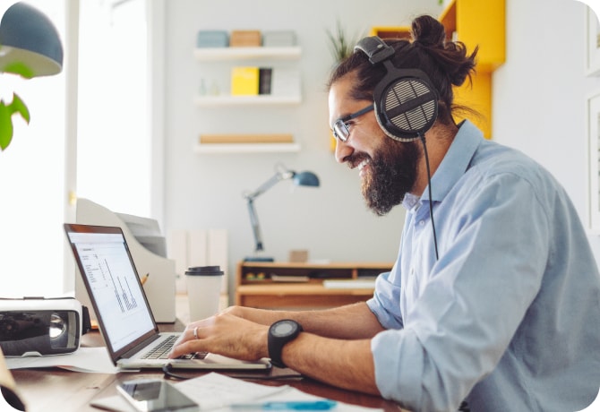 Young man using laptop with headphones