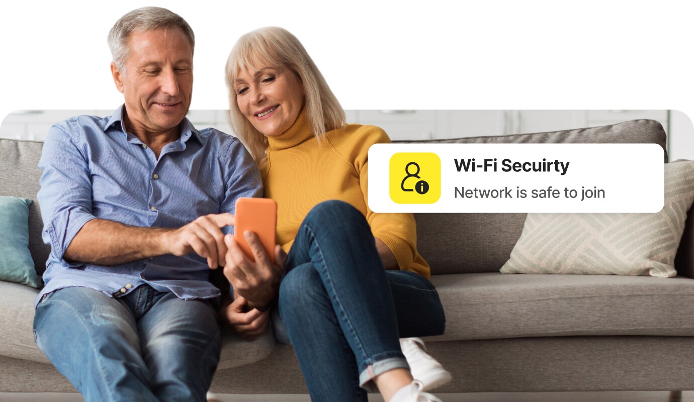 Couple on a couch looking at phone