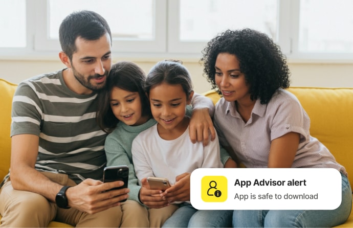 Family on couch collectively looking at phones